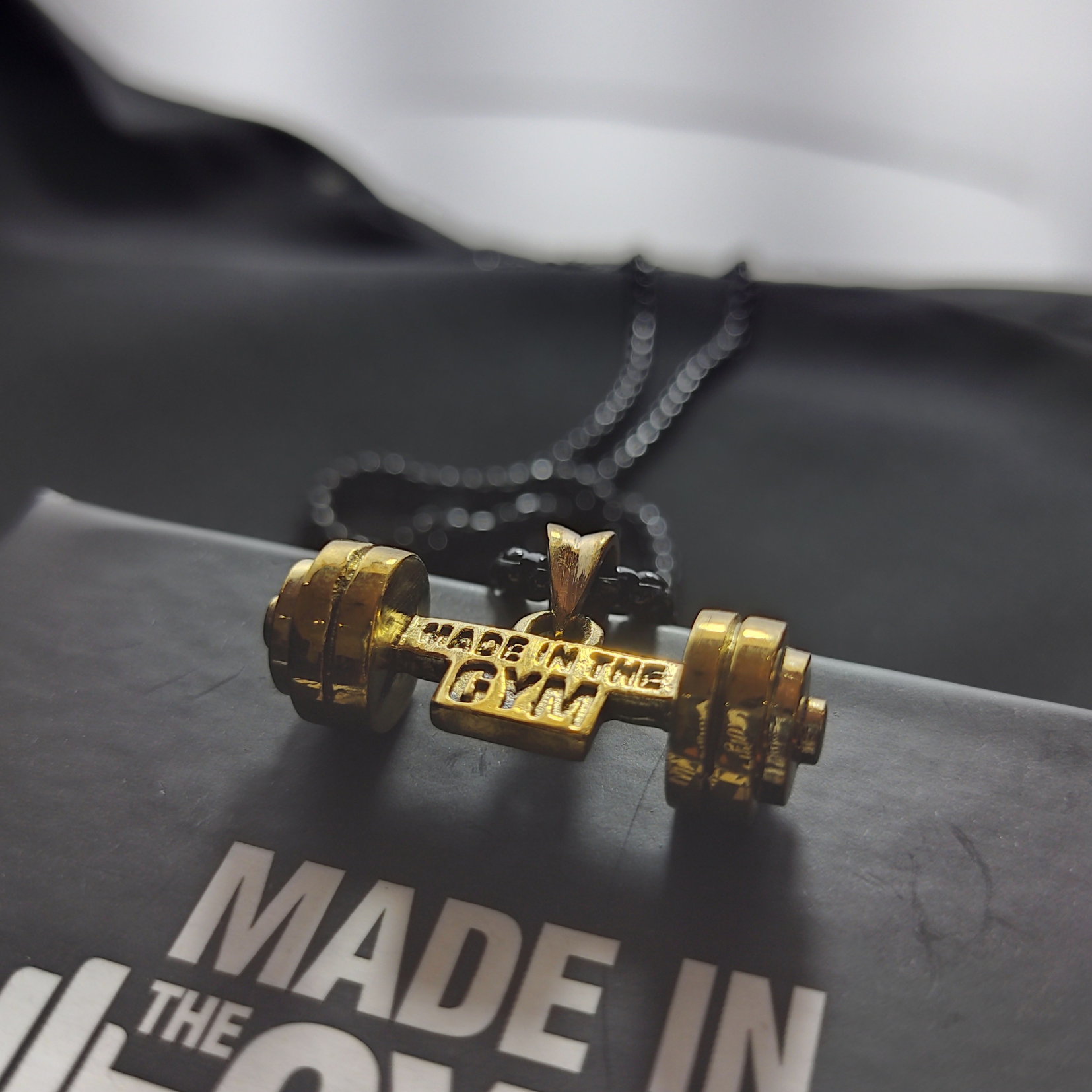 Made in the GYM pendant with branded packaging and card – premium unboxing experience for fitness lovers.