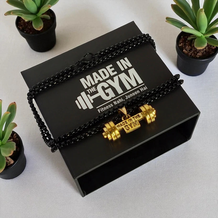 Black jewelry box with 'Made in the Gym' pendant on a light gray background.